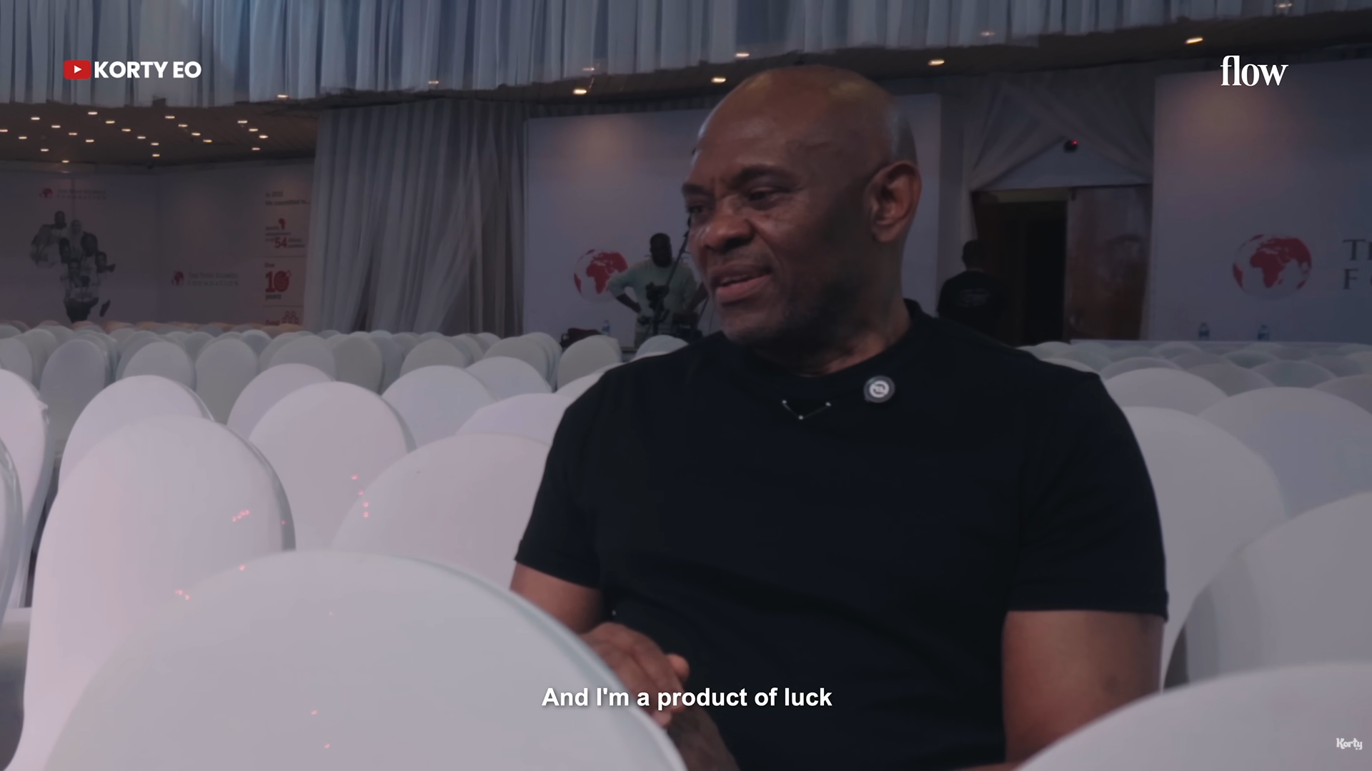 Tony Elumelu speaking with subtitle saying 'I'm a product of luck'